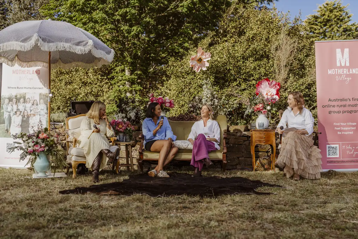 Four rural mums on stage at a Motherland Village event
