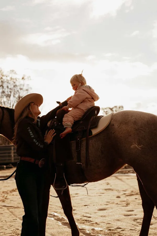 A mum riding a horse at sunset, from the Private Chat Room page