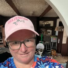 A Motherland Village mum in her pink cap