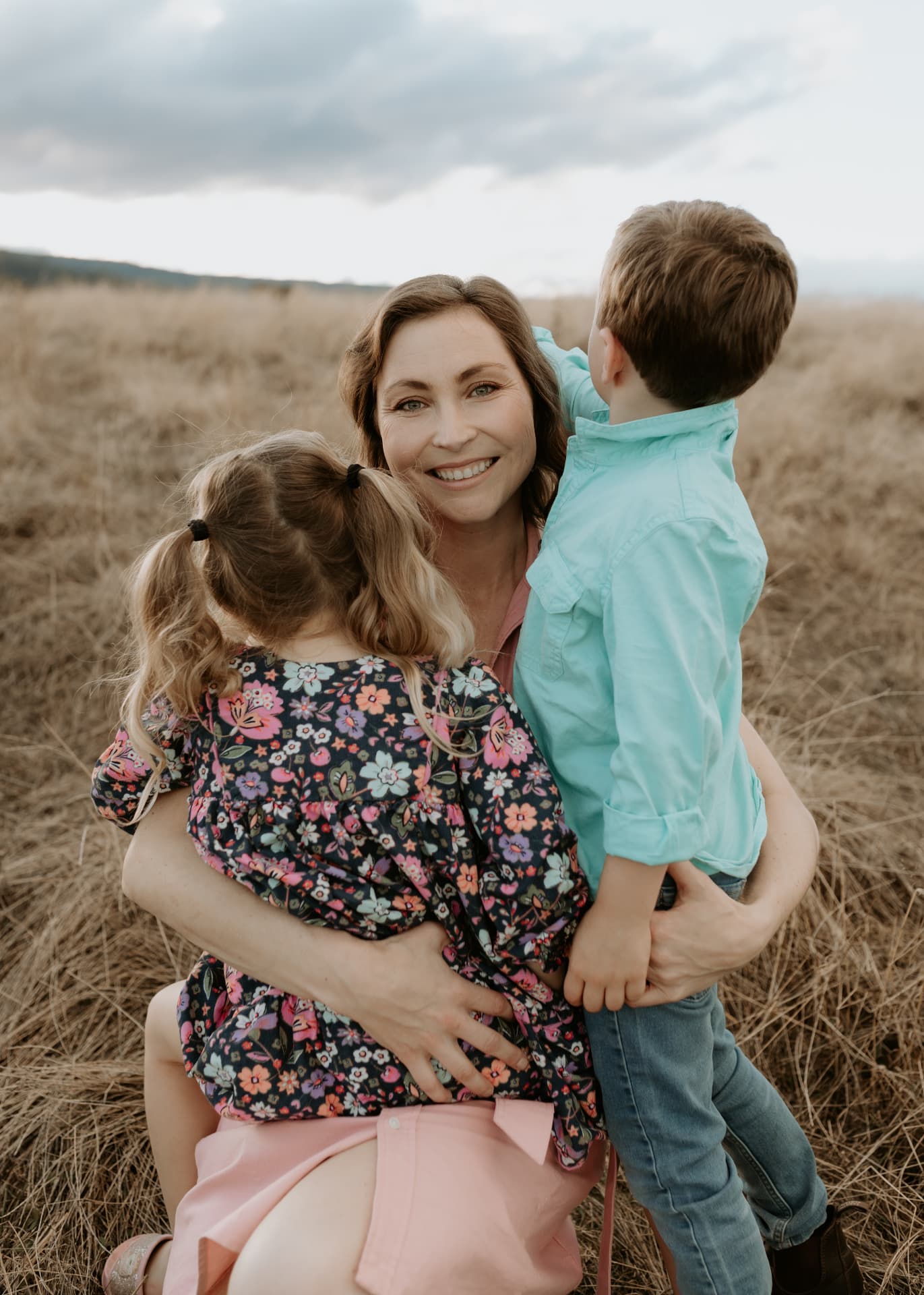 Steph Trethewey with her children in a rural paddock