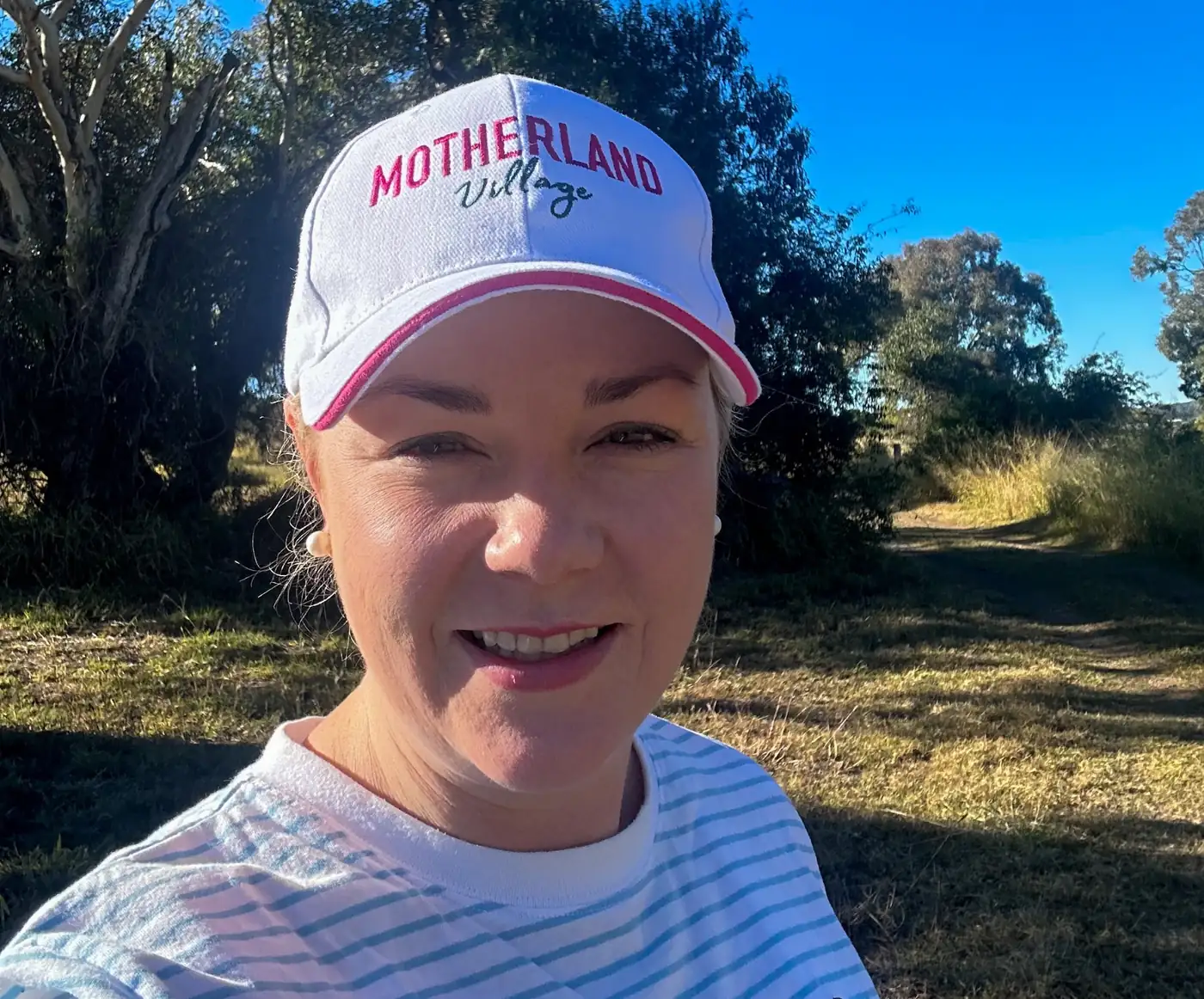 Lydia smiling in her Motherland Village cap