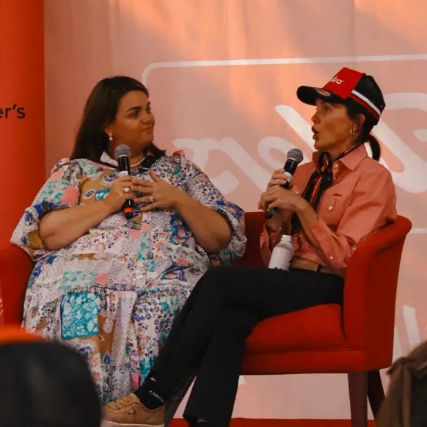 Steph in conversation on stage with a Motherland Village mum at a Motherland event